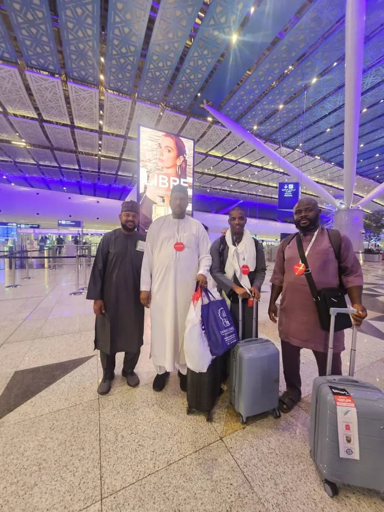 Pilgrims with luggage at the airport terminal before departure