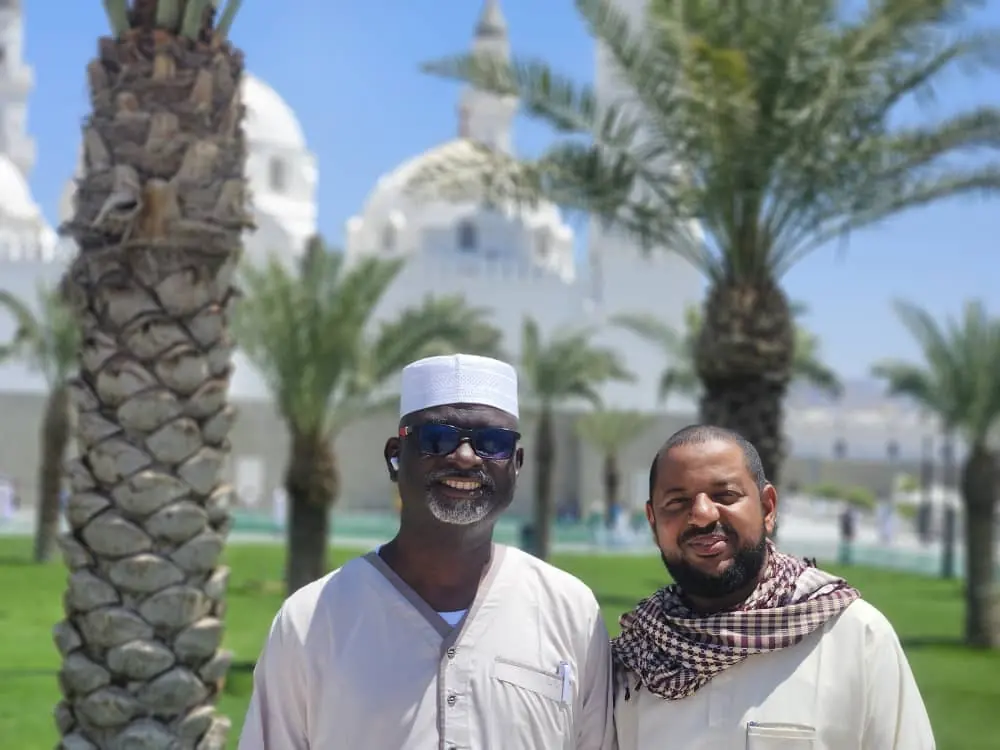 Two pilgrims outside a mosque in Madinah